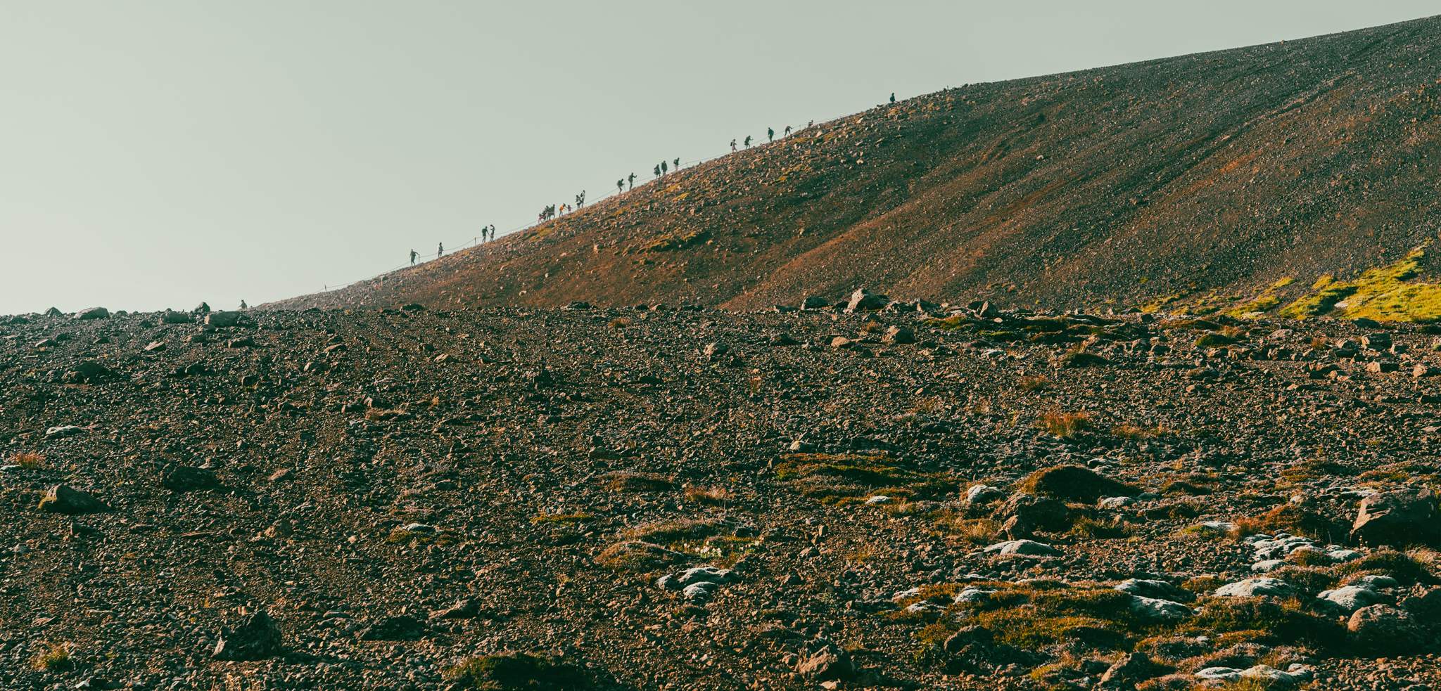 Visitors on the ridge of the hill leading above the valley