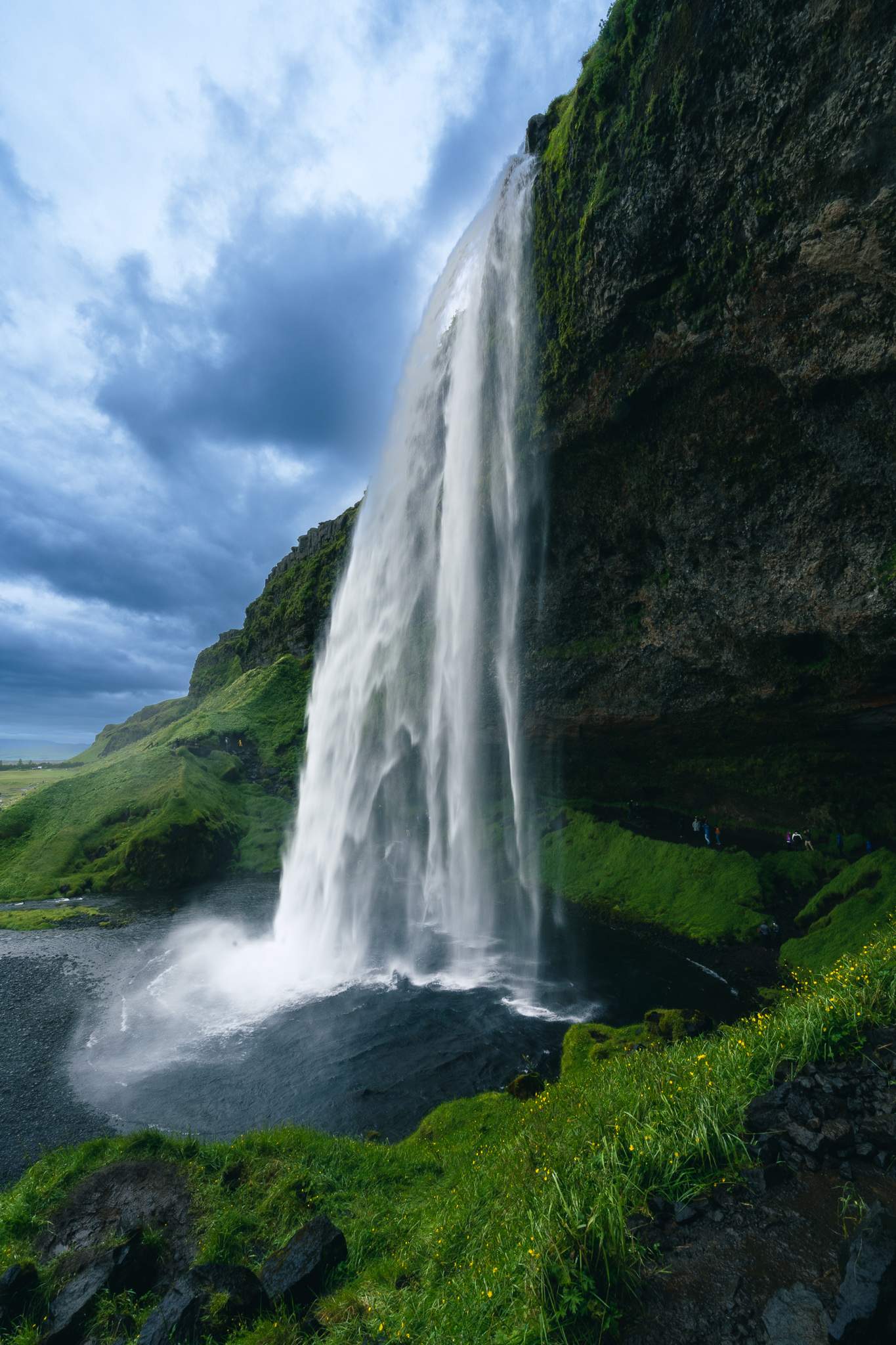 Vertical shot of Seljalandsfoss waterfall and its basin, Iceland