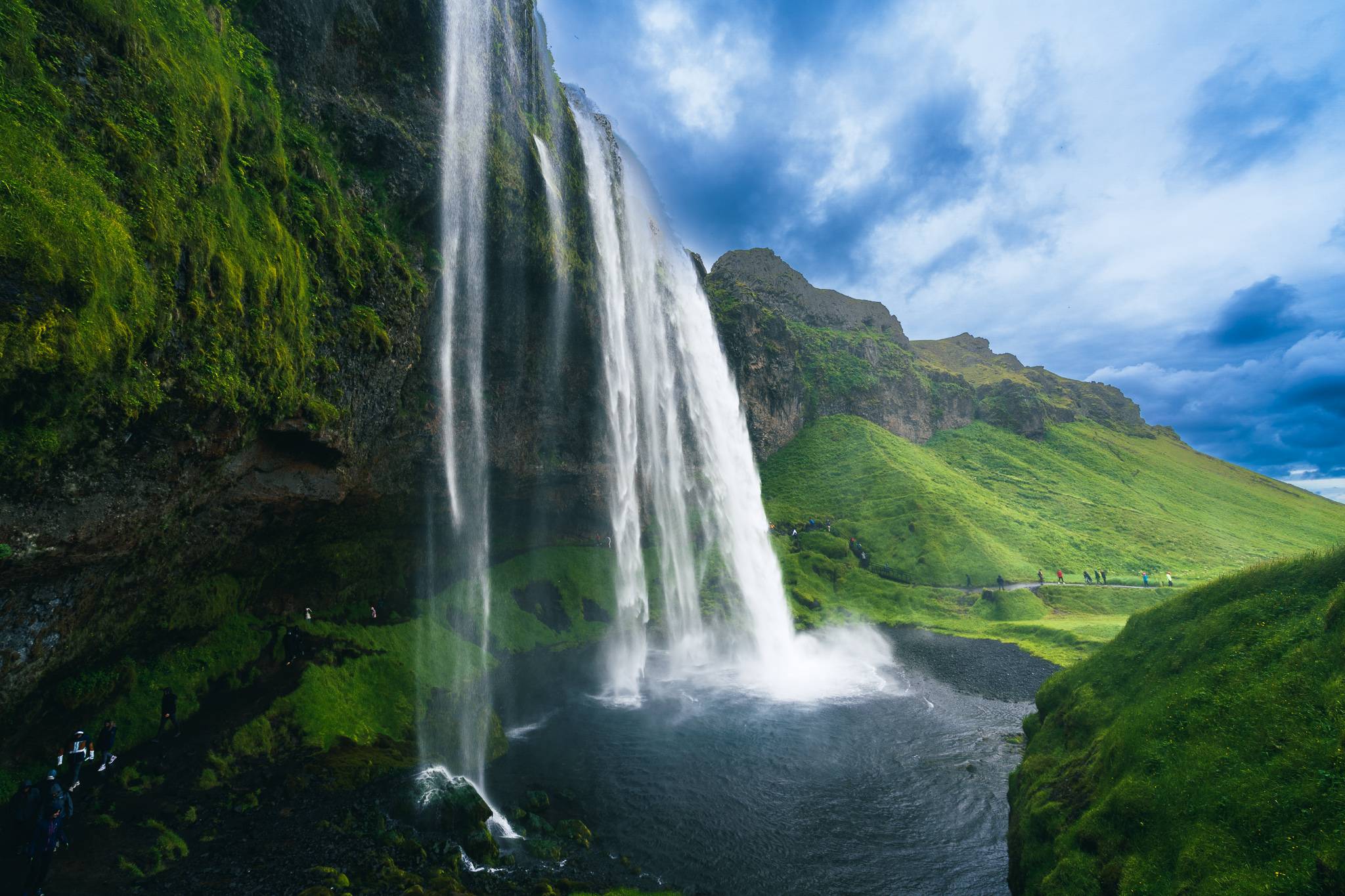 Final view of Seljalandsfoss waterfall after encircling it with the path in the cavern behind, Iceland