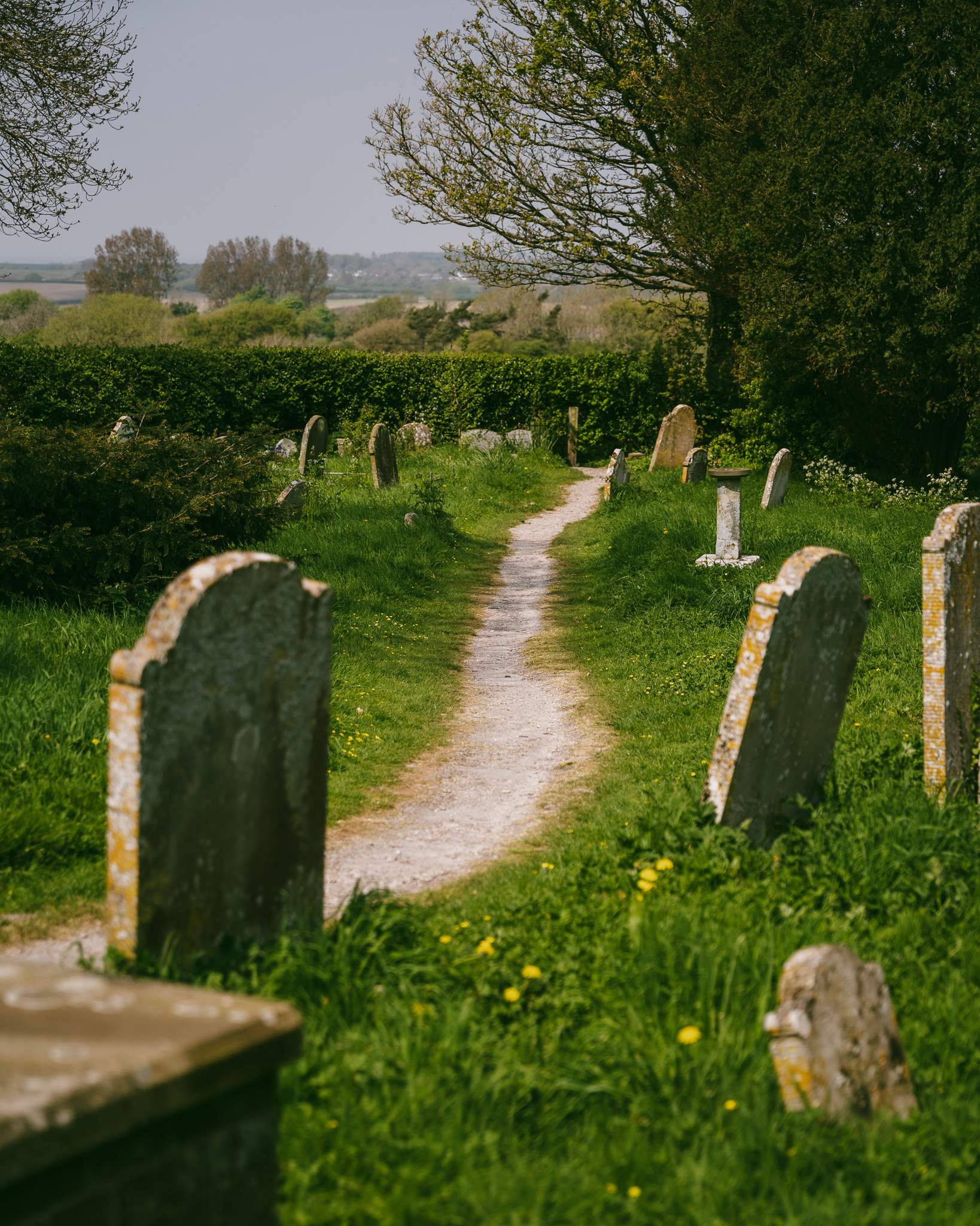 The churchyard of St. Mary and St. Peter's Church, Wilmington, East Sussex, England, UK